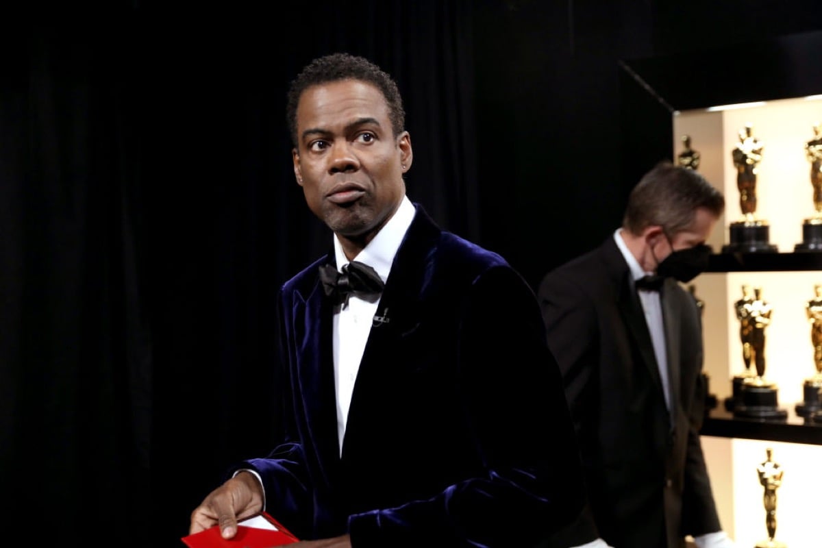 Chris Rock looking displeased while hosting the Oscars.