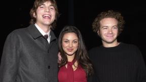 Ashton Kutcher, Mila Kunis, and Danny Masterson smile in a photo from the year 2000.