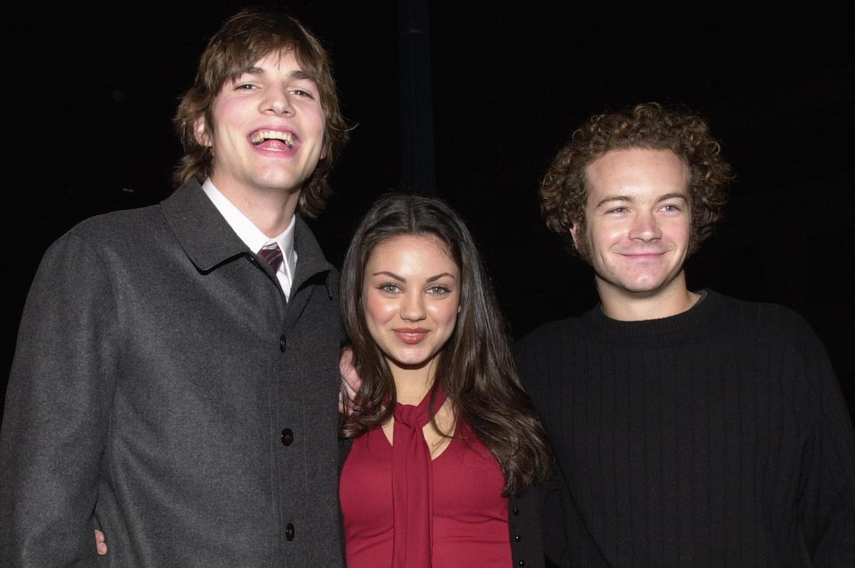 Ashton Kutcher, Mila Kunis, and Danny Masterson smile in a photo from the year 2000.