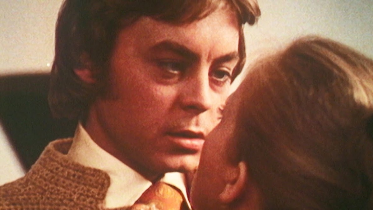 A man looking into a woman's eyes in Endless Night.