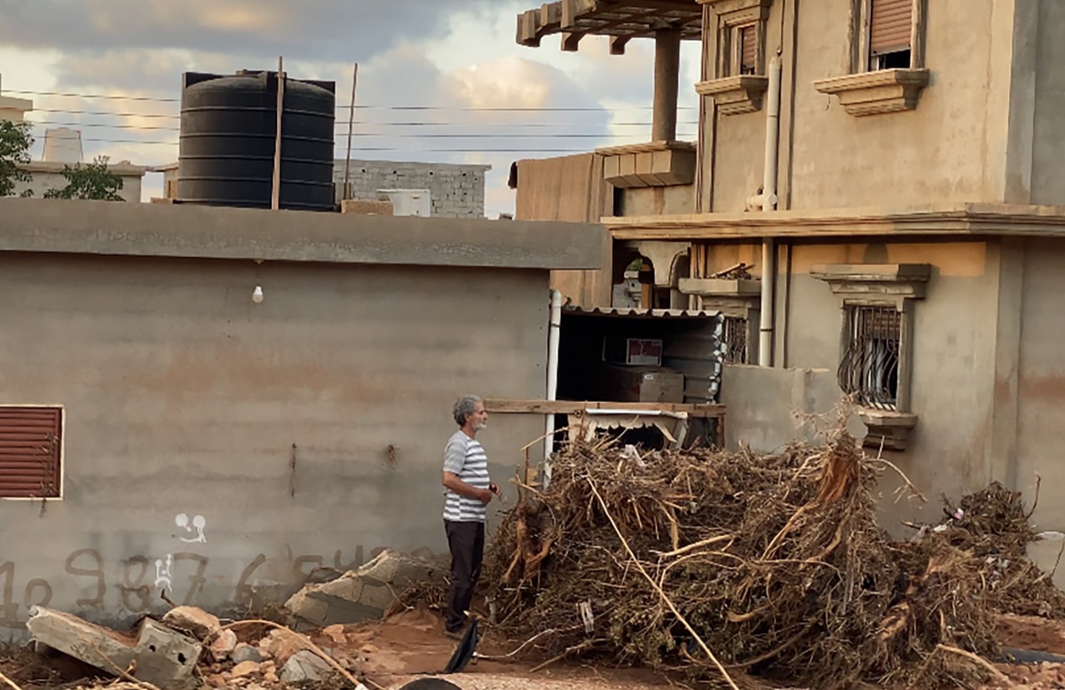 A person standing in the midst of flood damage in Libya.