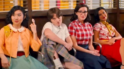 Characters in Grease: The Rise of the Pink Ladies sitting next to each other on a bench.