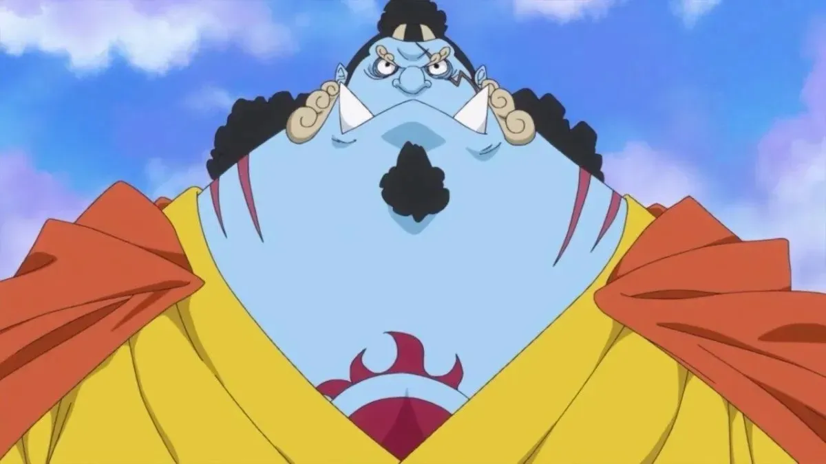 Jinbe frowning while standing against the blue sky in "One Piece"