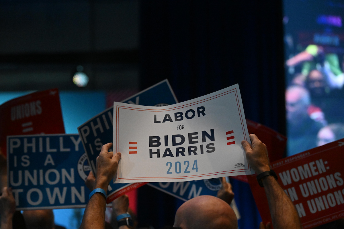 Supporters at a rally hold signs reading "Labor for Biden Harris"