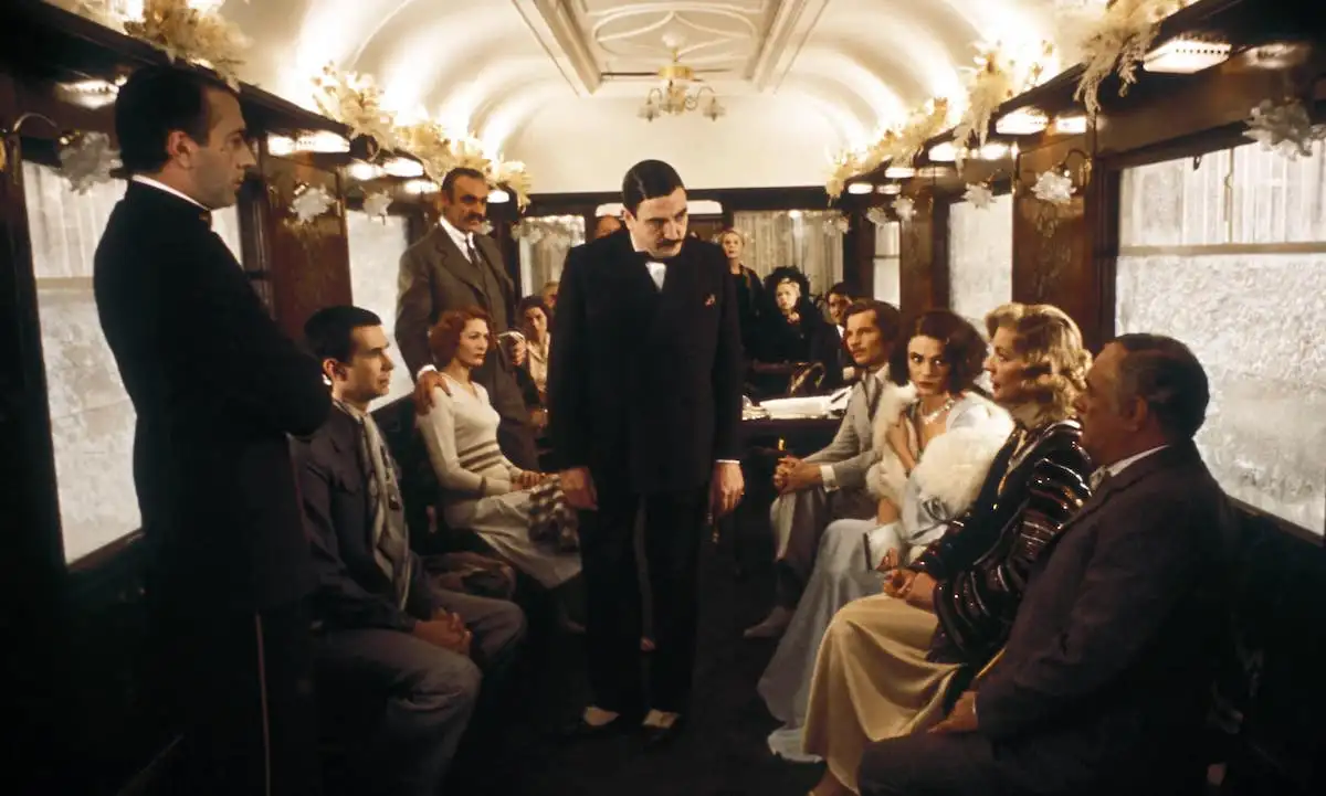The cast all together in a train car in Murder on the Orient Express.