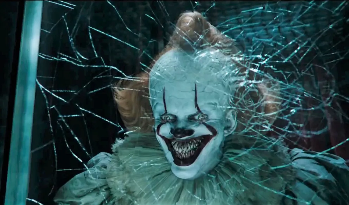 Pennywise (Bill Skarsgard) smashes his head on a glass wall in 'It Chapter Two'.