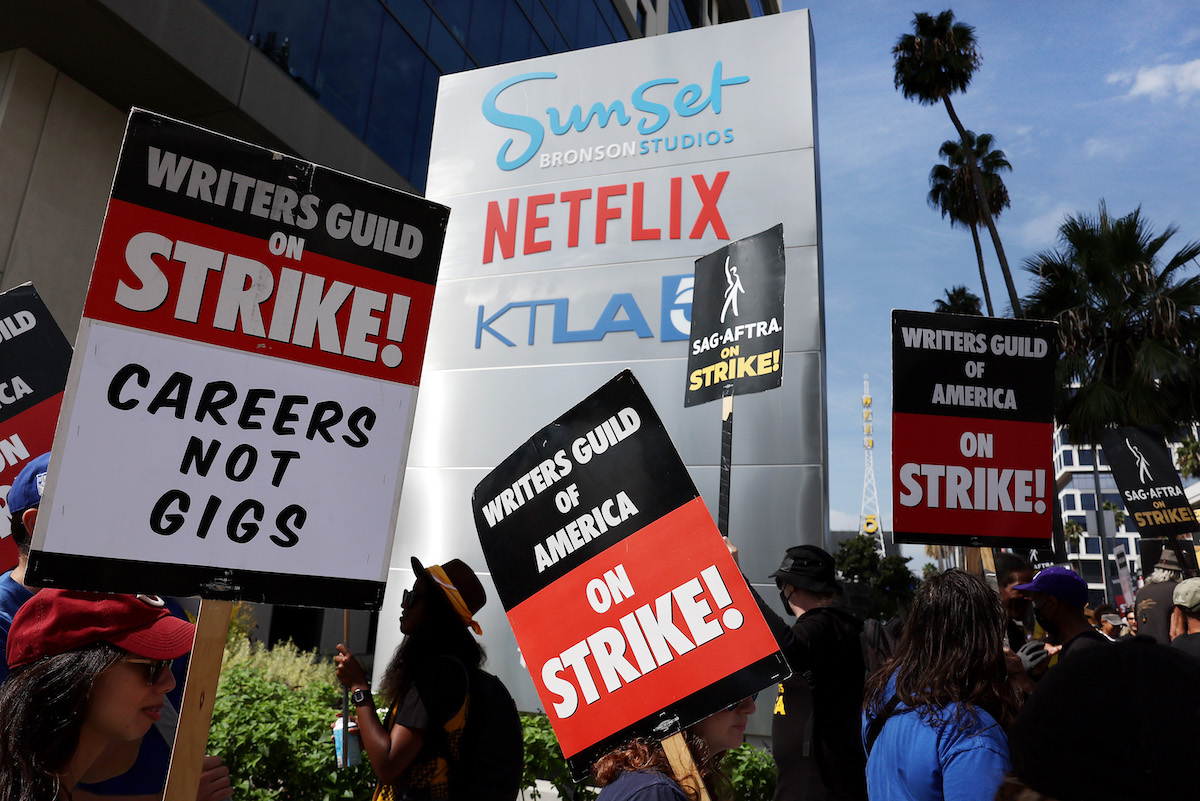 LOS ANGELES, CALIFORNIA - SEPTEMBER 22: Striking WGA (Writers Guild of America) members picket with striking SAG-AFTRA members outside Netflix studios on September 22, 2023 in Los Angeles, California. The Writers Guild of America and Alliance of Motion Picture and Television Producers (AMPTP) are reportedly meeting for a third straight day today in a new round of contract talks in the nearly five-months long writers strike. (Photo by Mario Tama/Getty Images)