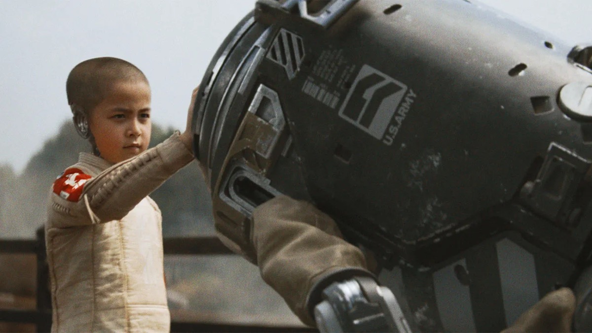 Alphie pressing her hand against a robot in 'The Creator'.