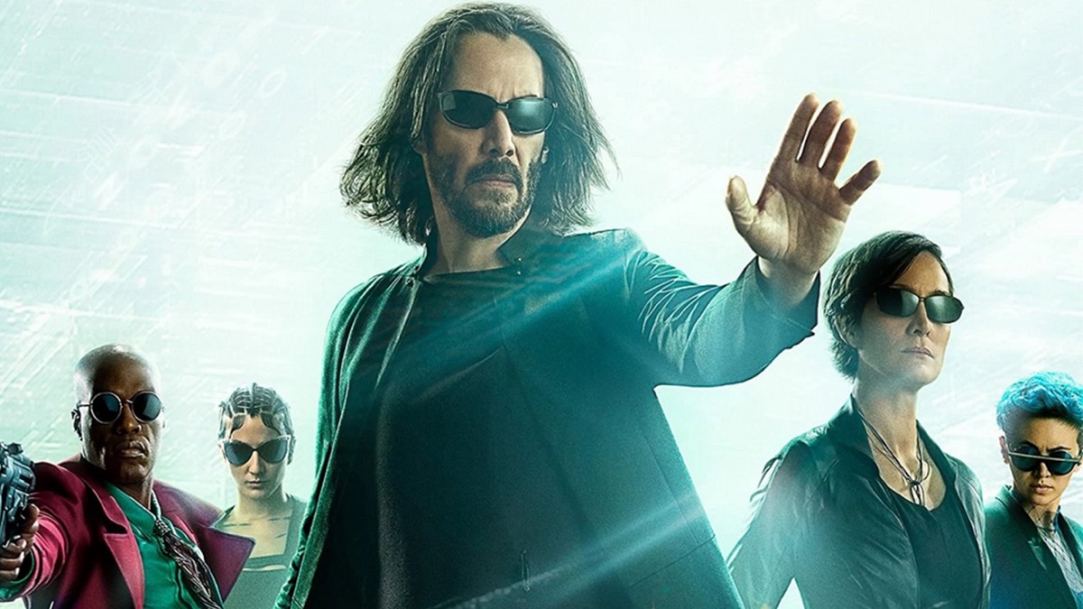 Neo stands with his hand out flanked by Trinity and Morpheus in the poster for "The Matrix: Resurrections"