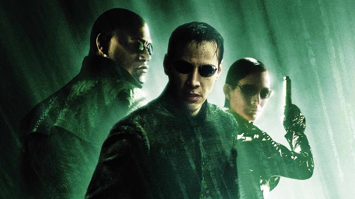 Neo, Trinity, and Morpheus stand in the rain in "The Matrix: Revolutions"