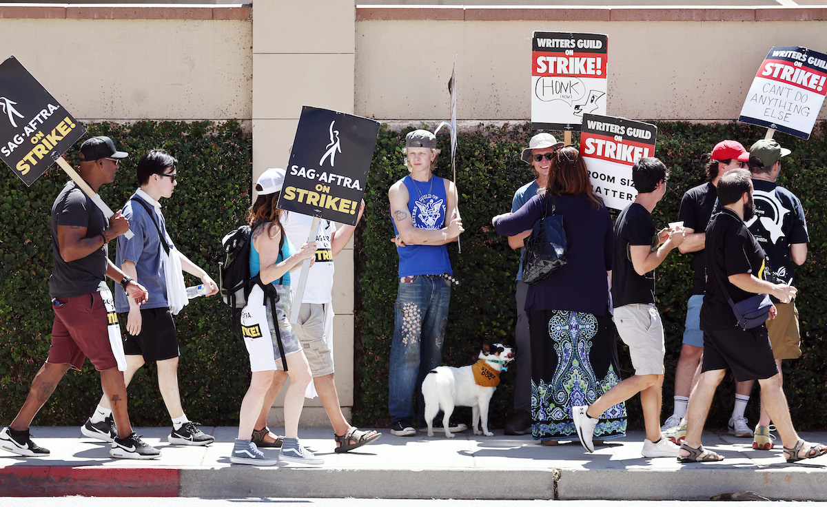 Striking writers and actors on a sidewalk picket line