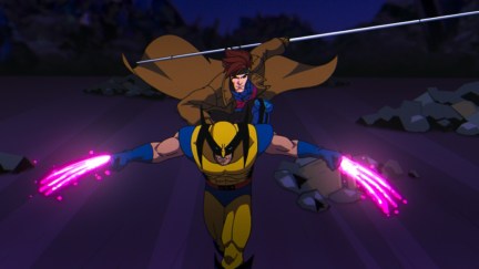 Gambit rides on Wolverine's back, charging his claws with electricity.