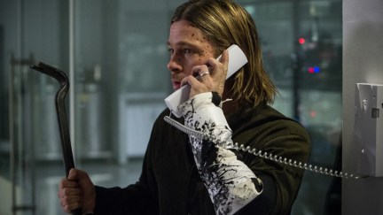 Brad Pitt holds a phone and a crowbar in 'World War Z'.