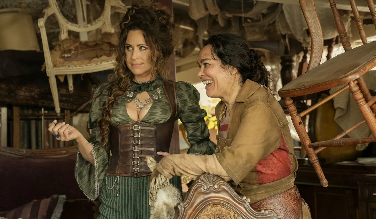 Two pirate women smile in a room full of antiques in 'Our Flag Means Death.'