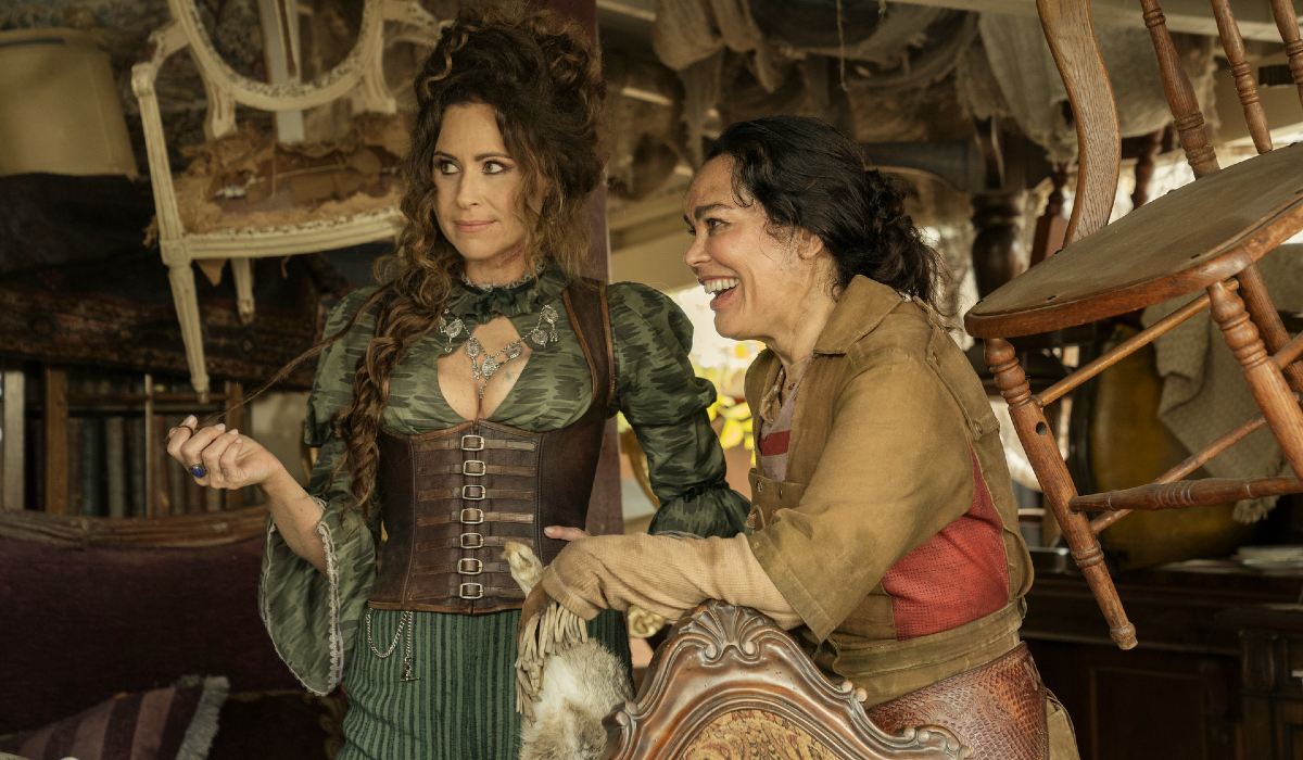 Two pirate women smile in a room full of antiques in 'Our Flag Means Death.'