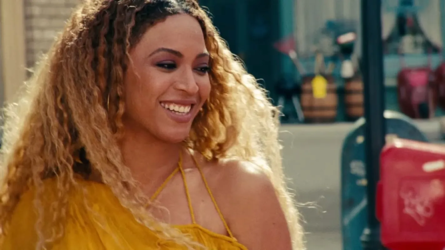Beyoncé the 'Hold Up' music video smiling and on that high that comes after destroying a bunch of cars in a neighborhood with a small bat stolen from a child. 