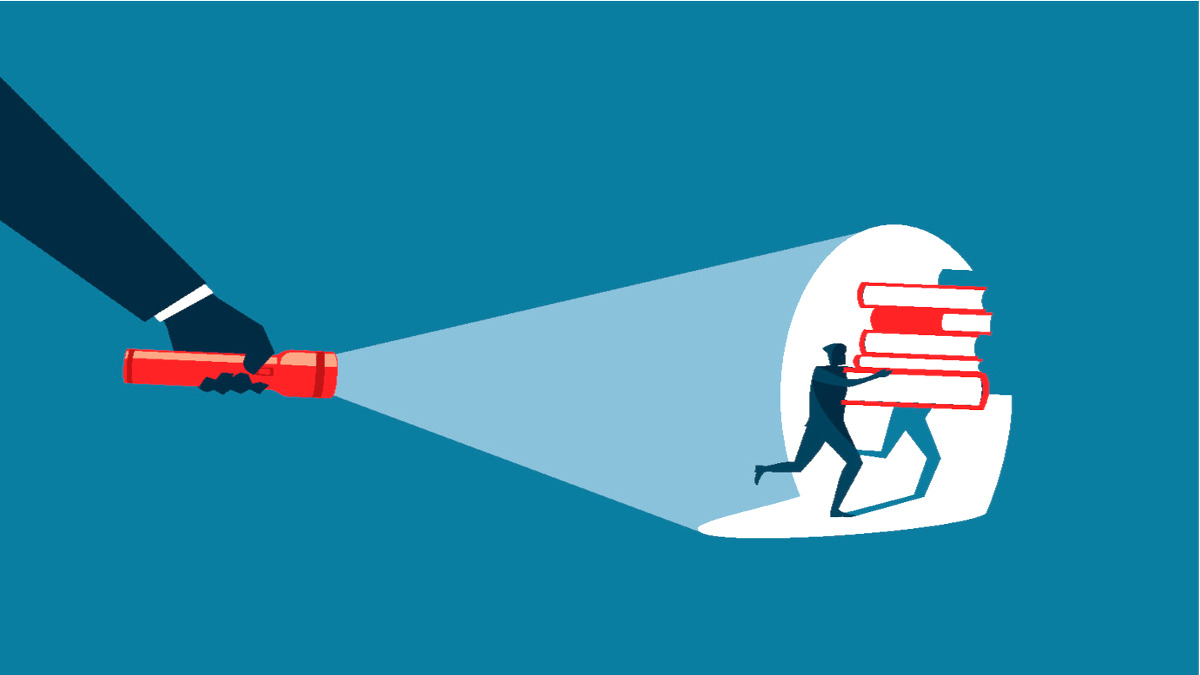 Someone shines a flashlight on a person stealing books