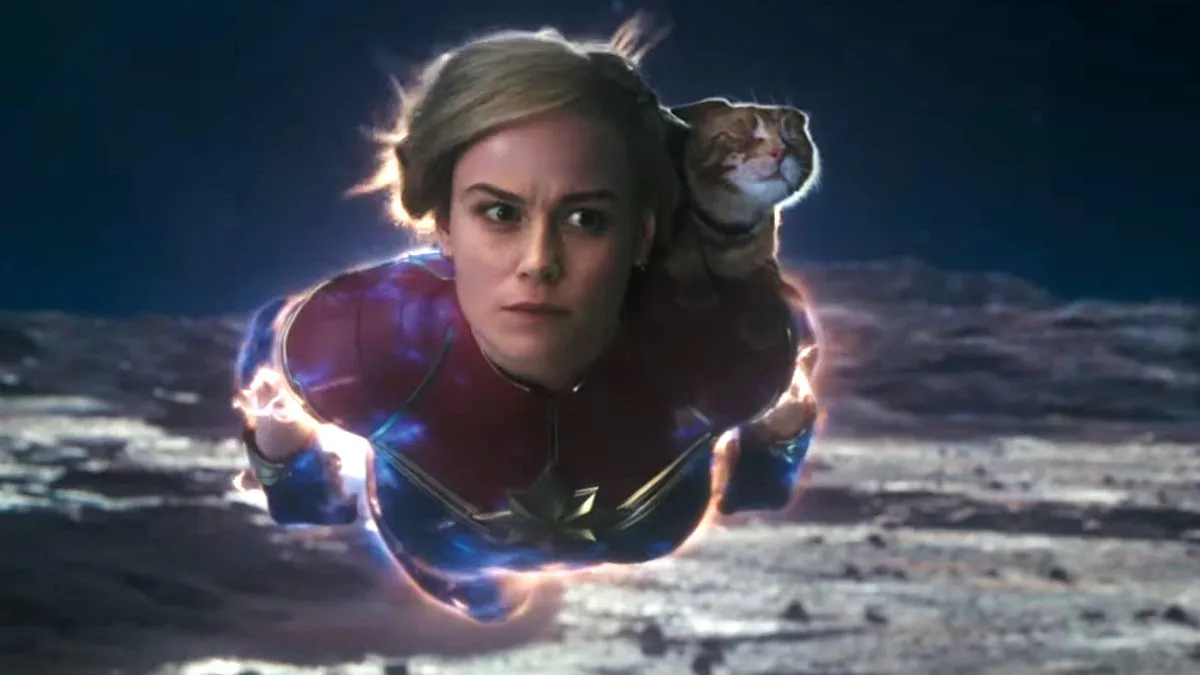 Woman flies through space with a cat on her back in 'The Marvels.'