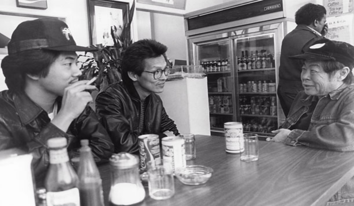 Wood Moy and Marc Hayashi sit at a table in 'Chan is Missing'.