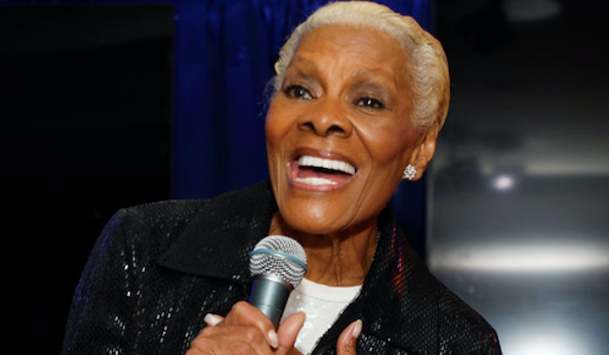 Dionne Warwick holds a microphone