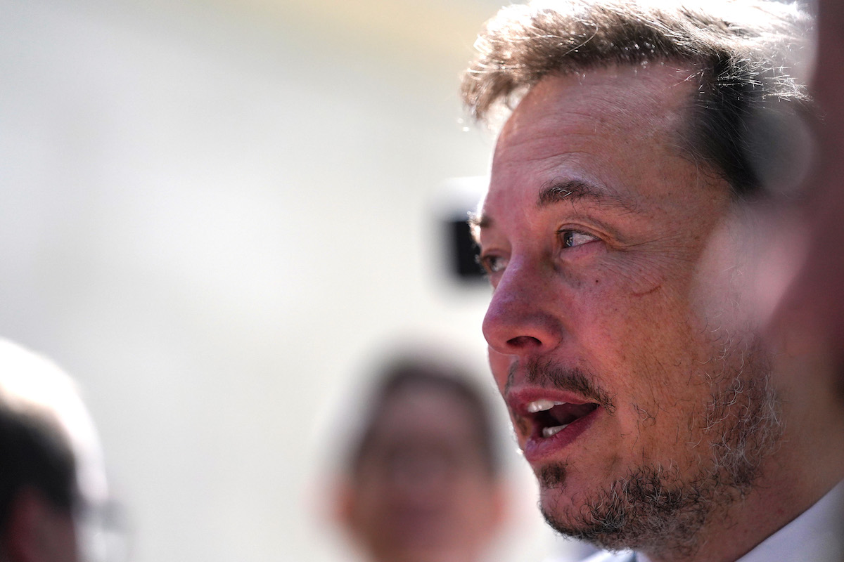 Elon Musk profile, blurred background