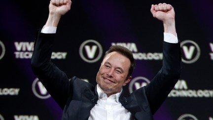 Tragically, Elon Musk looking very happy at a conference.