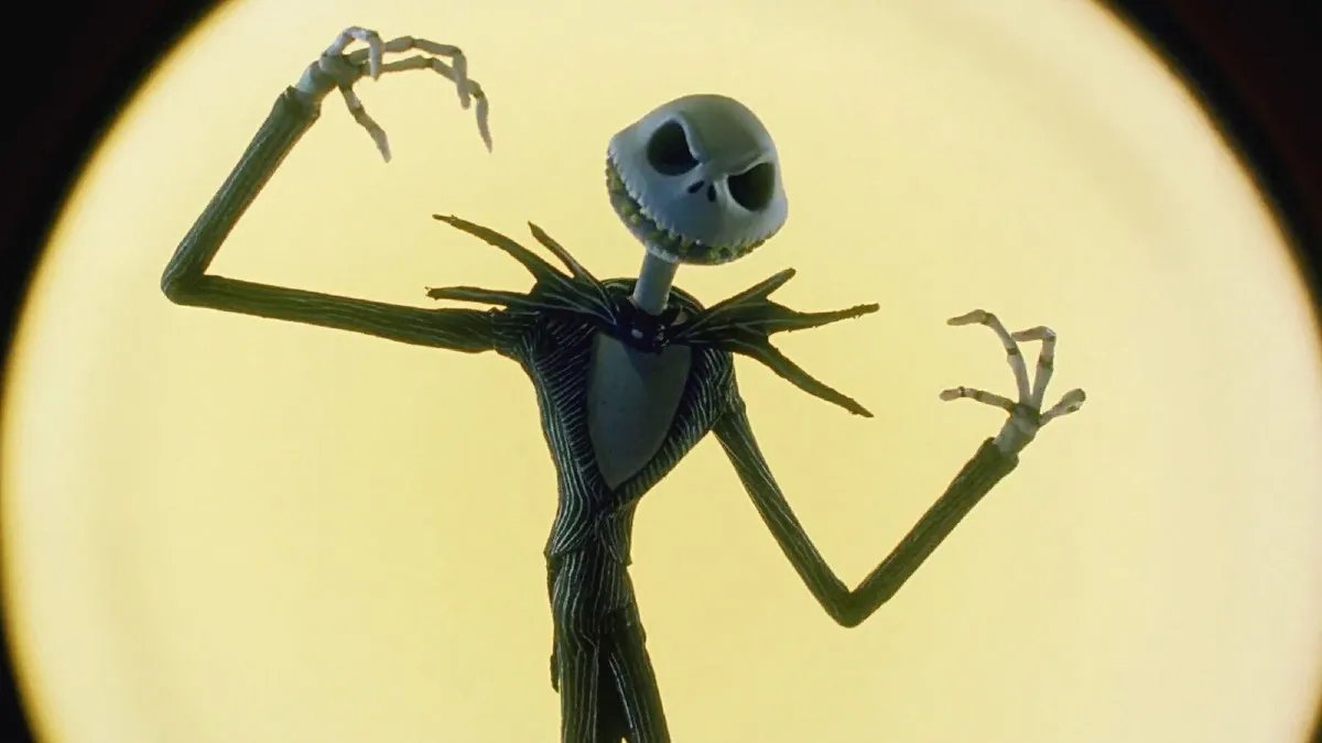 Jack Skellington standing in front of a glowing moon in 'The Nightmare Before Christmas.'
