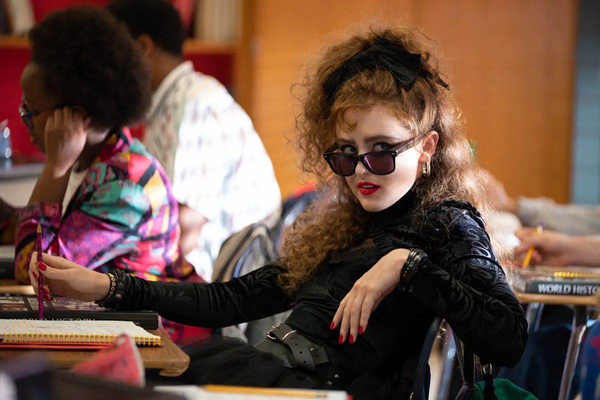 An 80s goth girl sits in a high school classroom in 'Lisa Frankenstein.'