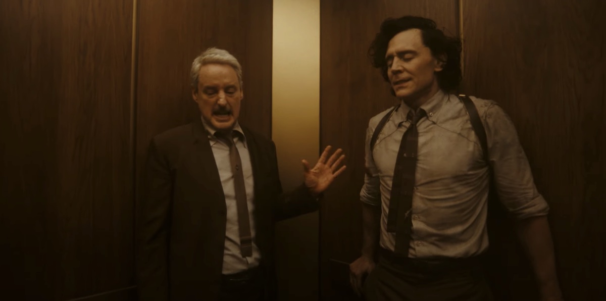 Mobius and Loki stand in an elevator, looking distraught.