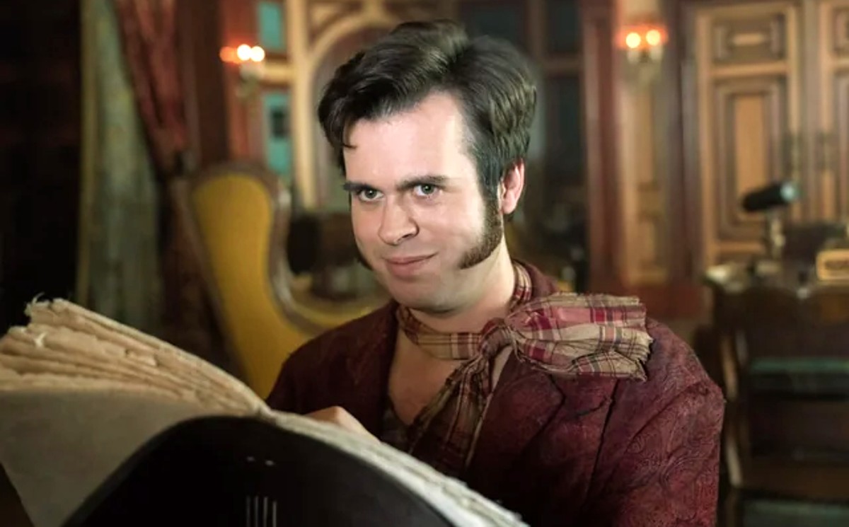 A pirate smiles while holding open a sketch book in 'Our Flag Means Death.'