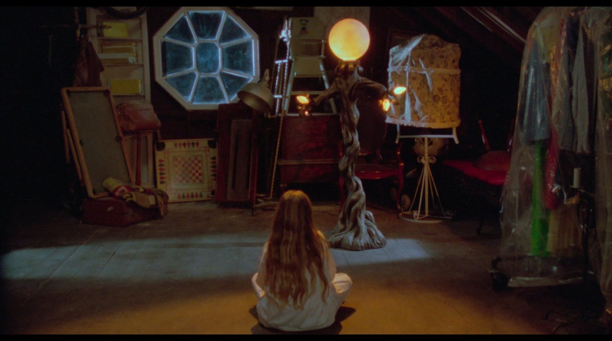 A girl sitting on the floor in Amityville 4: The Evil Escapes