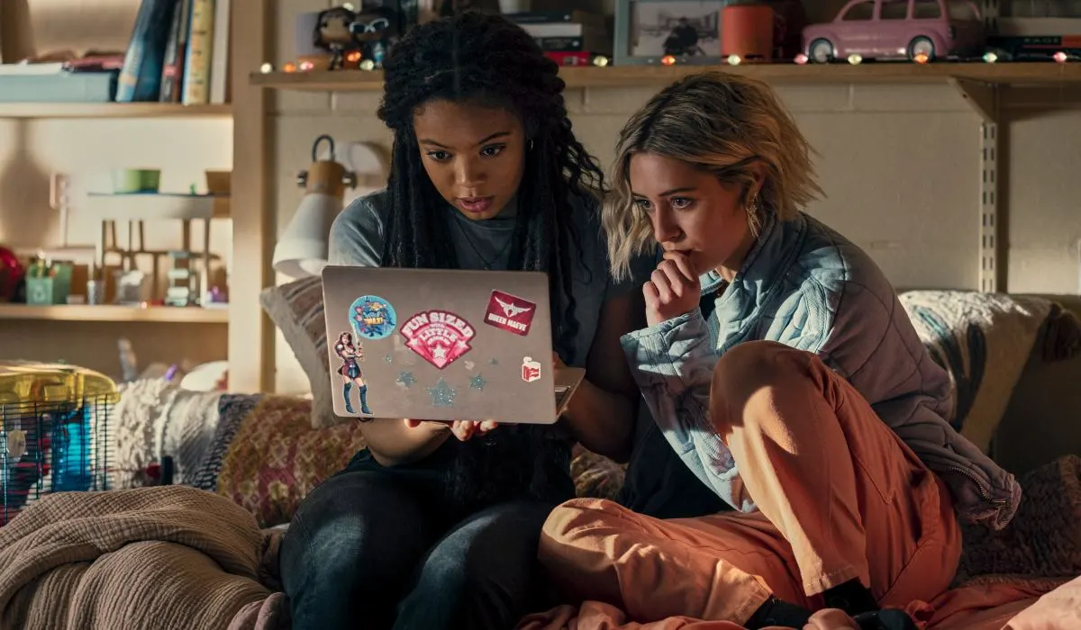 Jaz Sinclair as Marie and Lizzie Broadway as Emma in 'Gen V.' A white woman and a Black woman look at a laptop in a dorm room.
