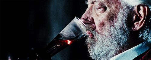President Snow drinks, leaving blood behind in the glass