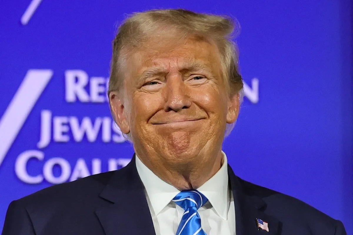 Trump head and shoulders, weird smile, against blue background