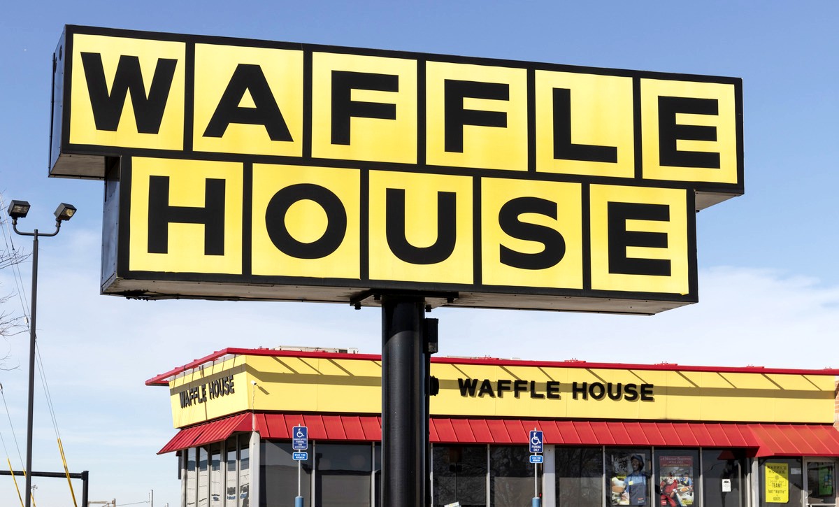 A sign outside of a Waffle House restaurant