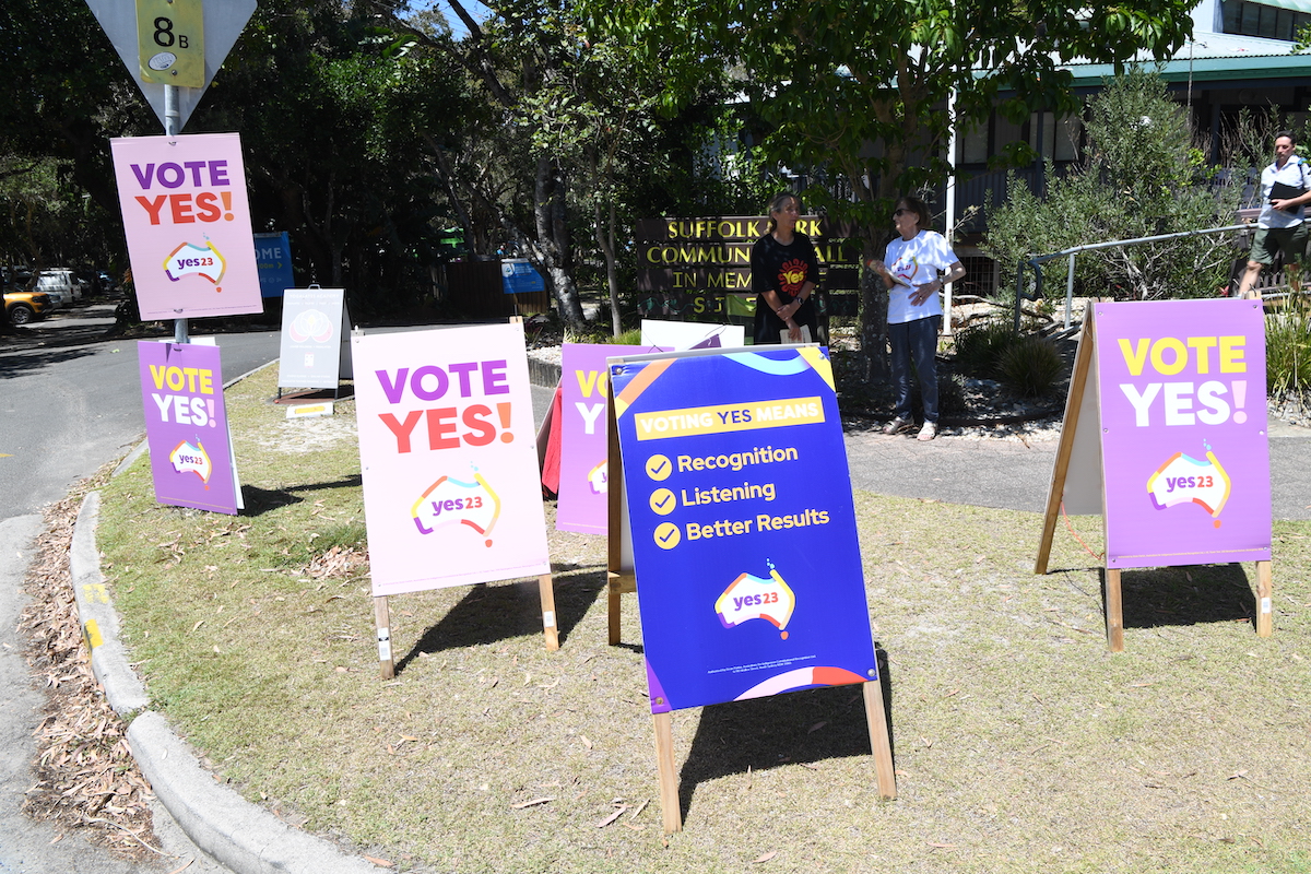 A collection of "Vote Yes" signs outside a polling place.