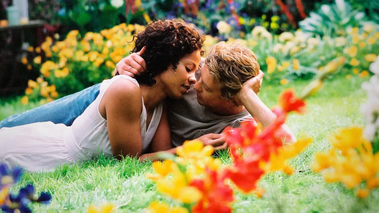 Sanaa Lathan as Kenya Denise McQueen and Simon Baker as Brian Kelly in 'Something New' kissing in the garden.