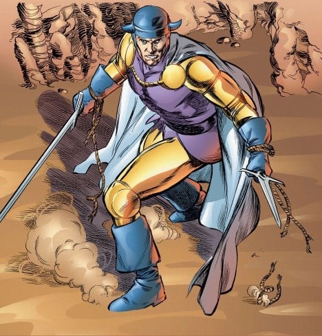 Balder the Brave in Marvel comics, holding two swords. He's wearing a sylver helmet and cape, a purple leotard, and yellow sleeves and leggings.