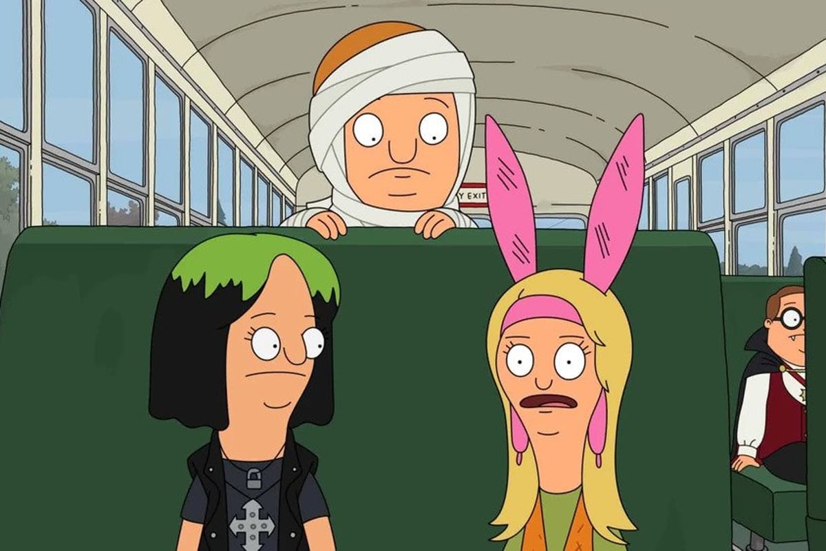 Still from Bob's Burgers episode Apple Gore-chard!; Jessica and Louise sit on a bus with Rudy leaning over the seat behind them. They're all in costume, Rudy is a mummy, Jessica is a Billie Eyelash mashup, and Louise is a character from Twister.
