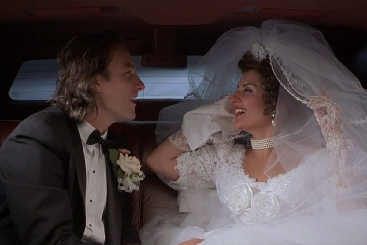 John Corbett as Ian Miller and Nia Vardalos as Toula Portokalos in 'My Big Fat Greek Wedding' in the back of a car after their wedding.