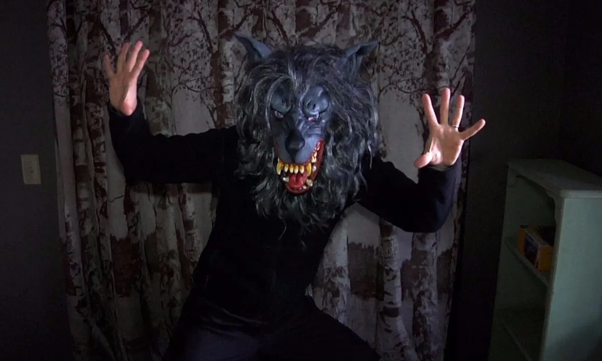 A man wearing a werewolf mask jumps out. "creep up"