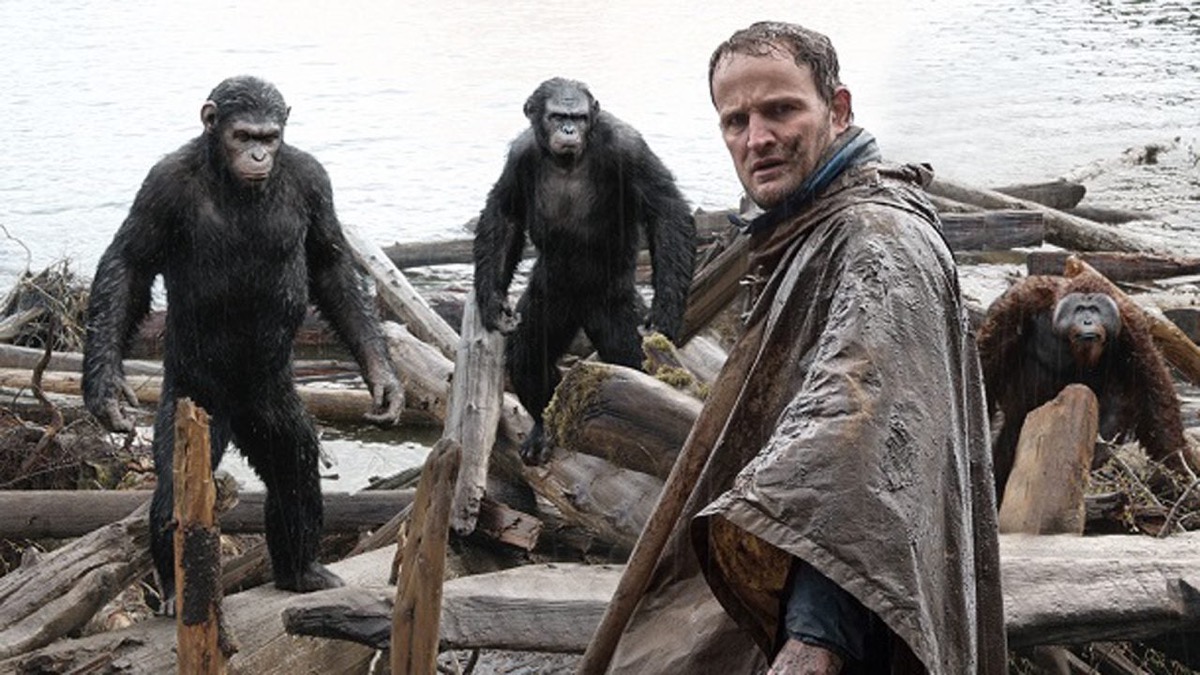A human stands with a group of apes in "Dawn of the Planet of the Apes"