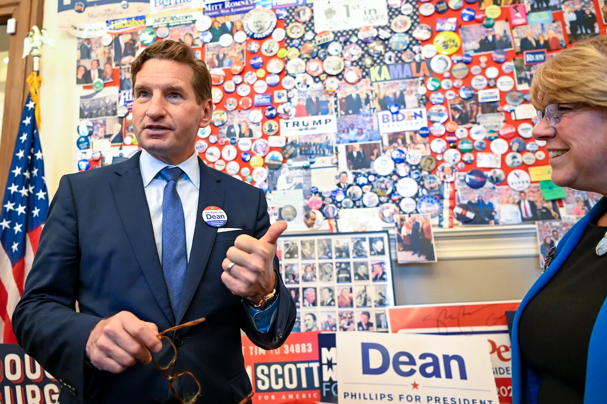 Dean Phillips (D-MN)(R) visits the candidate wall at the N.H. Statehouse