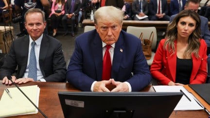 Donald Trump stares into the camera, sitting in court.