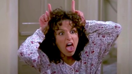 Elaine makes mocking devil horns on her head in Seinfeld.