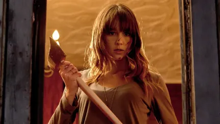 A young woman holds an ax in 