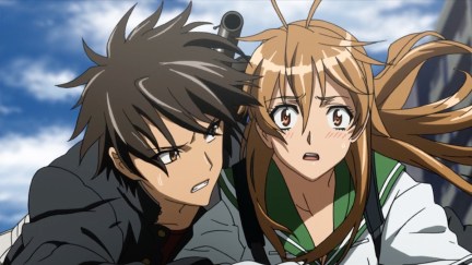 A highschool girl stares with a shocked look on her face while a boy holds on to her in 