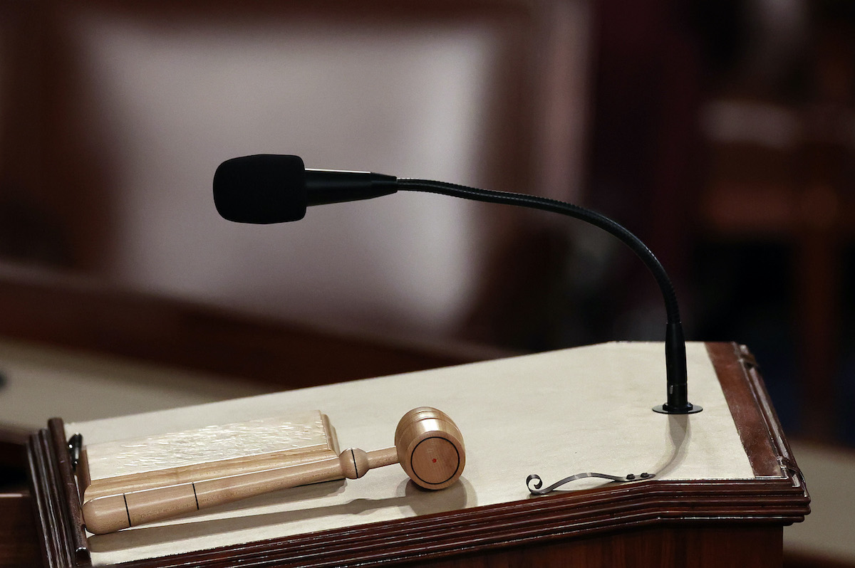 A closeup on the House Speaker's podium, with a gavel resting on it.
