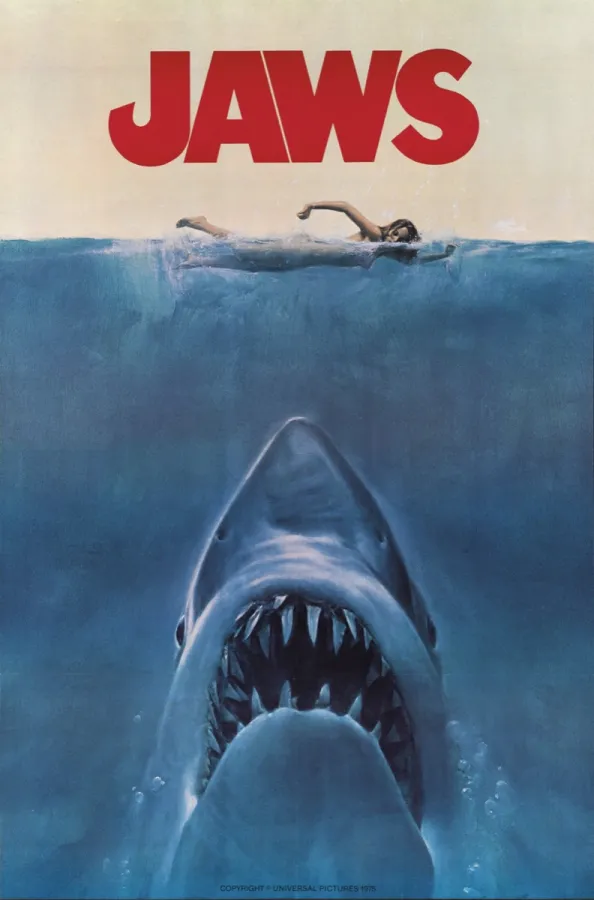 A woman swims in the ocean with a shark beneath her in the poster for "Jaws"