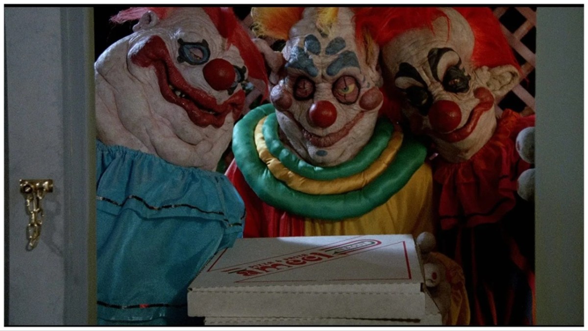 Three killer klowns from outer space stand at the door holding a pizza box in 
